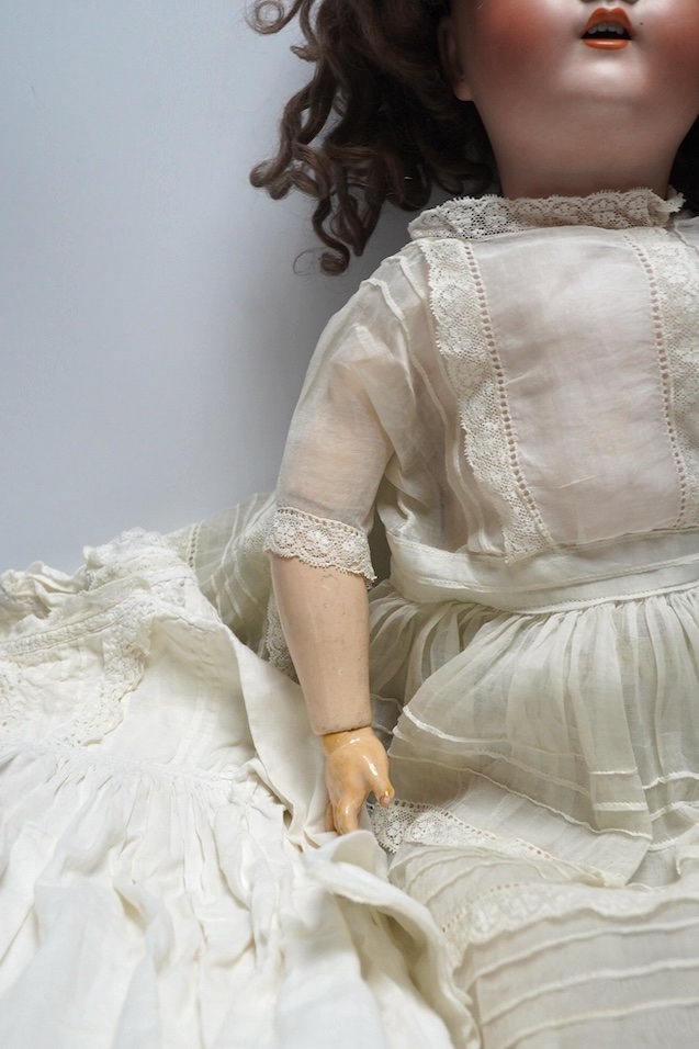An Alt. Beck & Gottschalk bisque doll and three baby dresses, 61cm high. Condition - no visible hairline cracks to head or serious damage to body, dresses and dolls dress in good order, may need washing